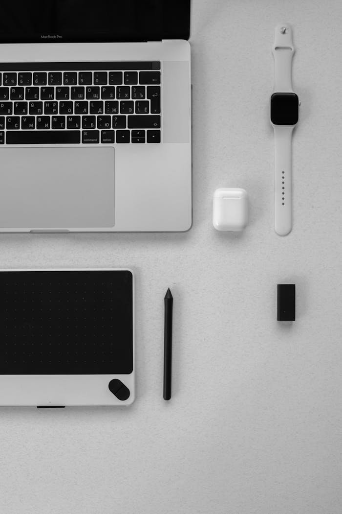 services-03 Clean and minimalist workspace arrangement featuring laptop, tablet, and smartwatch.